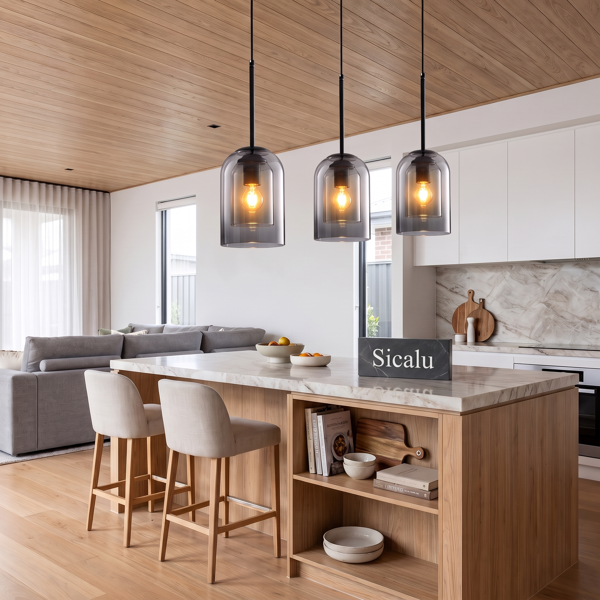 Nordlys pendant lights above a kitchen island with a Sicalu sign
